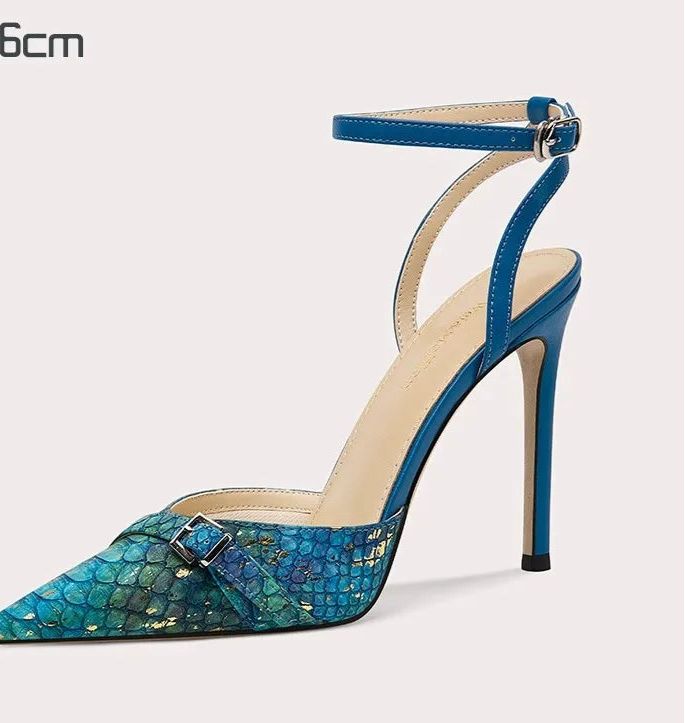 Blue high-heeled shoe with a patterned toe on a white background