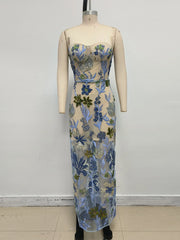 Floral strapless dress on a mannequin against a white background