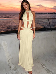 Pale yellow halter neck cutout maxi dress at sunset