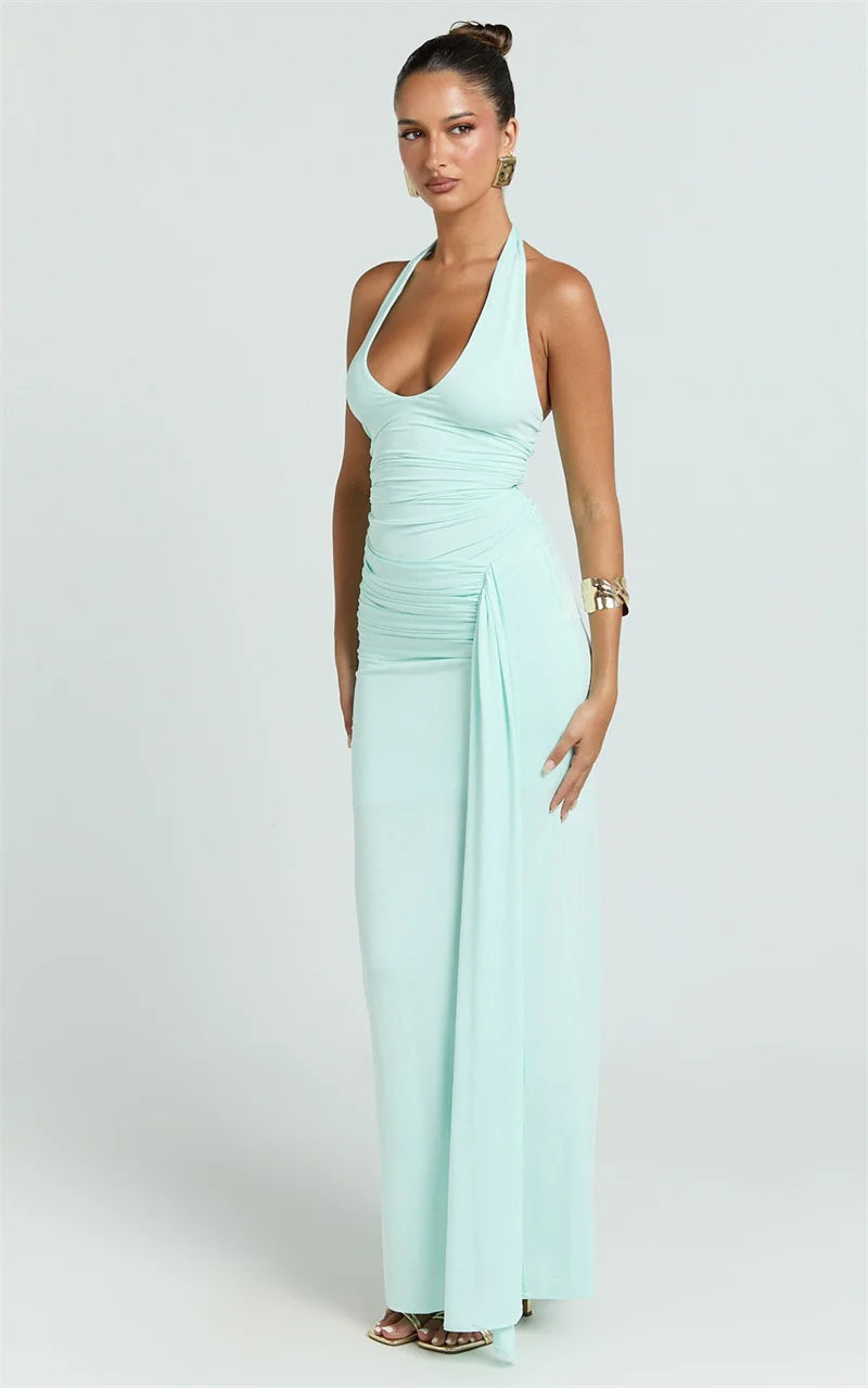 Woman wearing a light blue halter neck gown on a white background