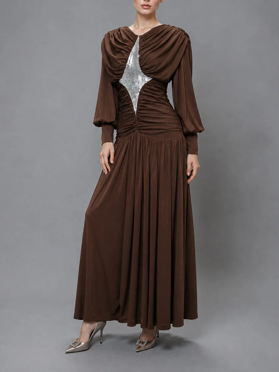 Model wearing a brown sequined draped maxi dress.