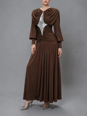 Model wearing a brown sequined draped maxi dress.