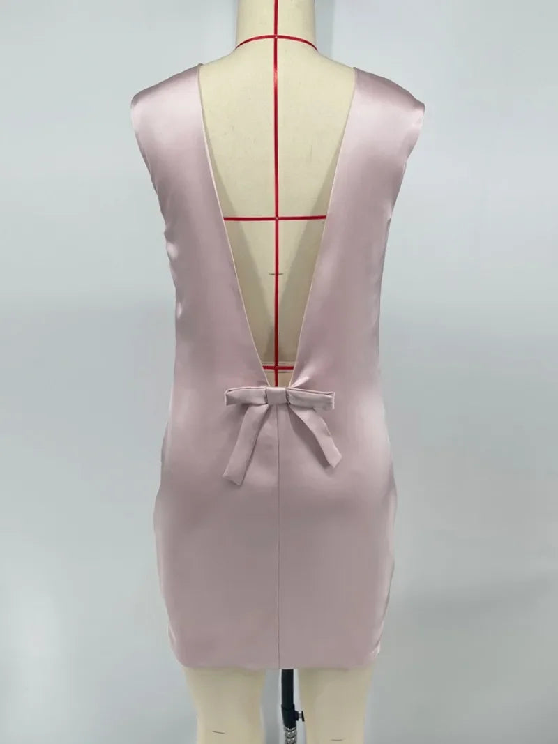 Pink dress on a mannequin with a plain background