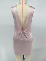 Pink dress on a mannequin with a plain background