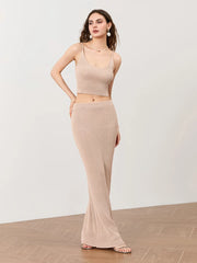 Woman wearing a beige sleeveless top and skirt set