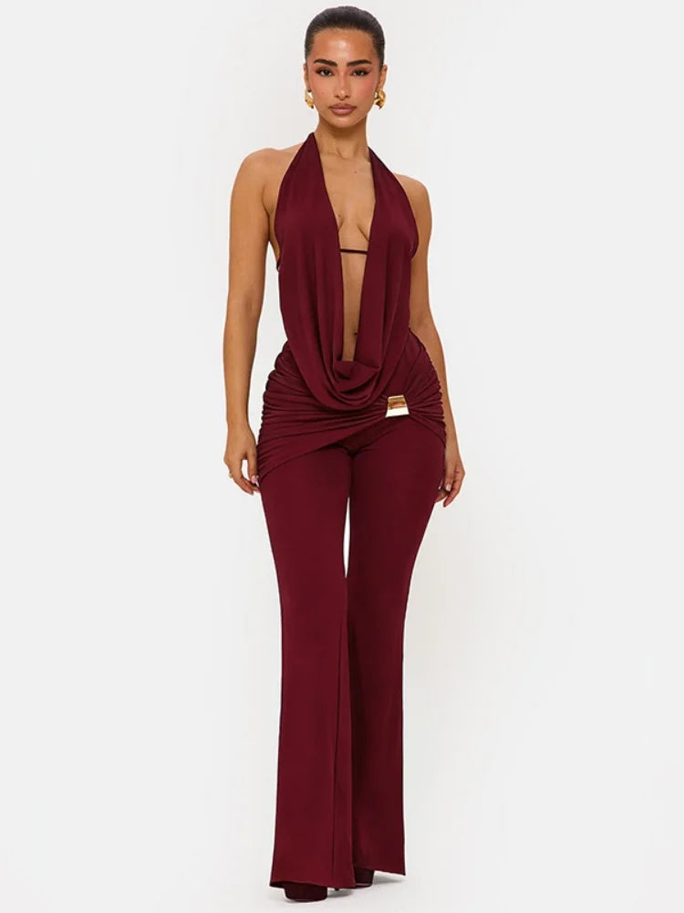Woman wearing a burgundy jumpsuit on a white background