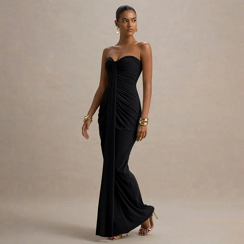 Woman wearing a black strapless gown on a beige background
