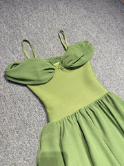 Green dress on a textured gray surface