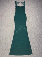 Green dress with cut-out back on a gray surface
