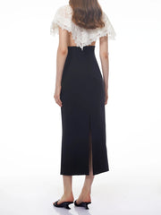 Sheath dress with a white lace cape overlay, back view.