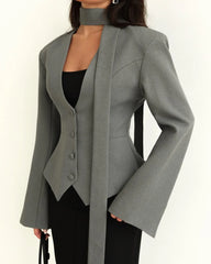Gray blazer worn by a person on a white background