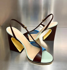 Colorblock slingback block heels displayed on a metallic surface.