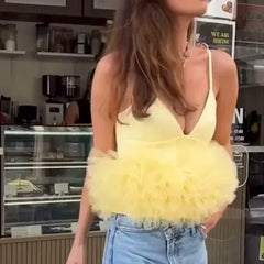 Woman wearing a yellow fluffy top in a store setting