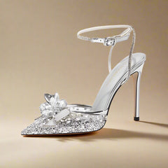 Silver high-heeled shoe with floral design on a white background