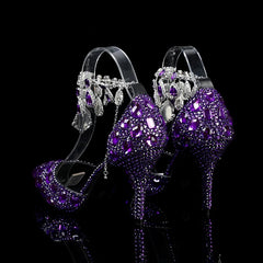 Purple high-heeled shoes with crystal embellishments on a black background