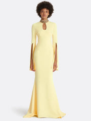 Yellow maxi dress with cape sleeves and beaded neckline on model