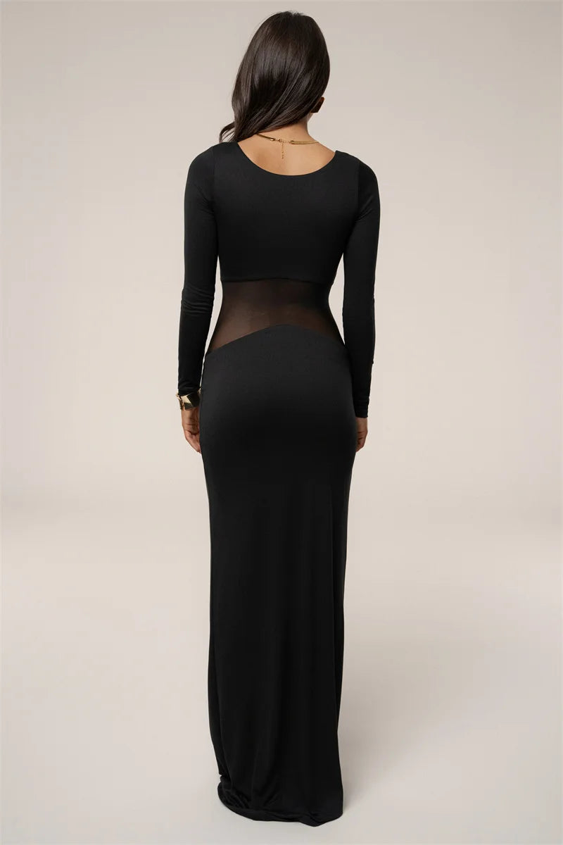 Black long-sleeve dress with sheer panels on a plain background