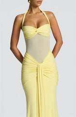 Yellow evening gown with a fitted bodice and flowing skirt on a plain background