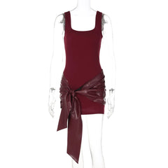 Maroon dress with a large bow on a mannequin against a white background