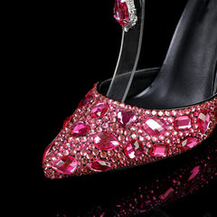 Black high-heeled shoe with pink gemstones on a black background