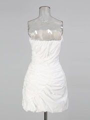 White strapless dress on a mannequin against a gray background