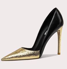 Black and gold high-heeled shoe on a light gray background