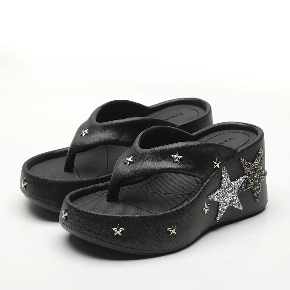 Black platform wedge heels with star embellishments
