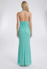 Woman wearing a turquoise evening gown in a photo studio setting