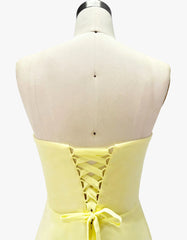 Yellow dress on a mannequin with a white background