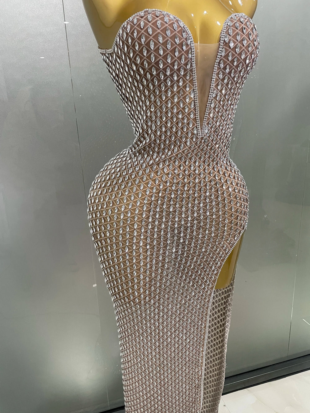 Silver mesh dress on a mannequin against a neutral background