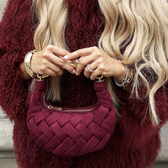 Person holding a woven faux suede top.