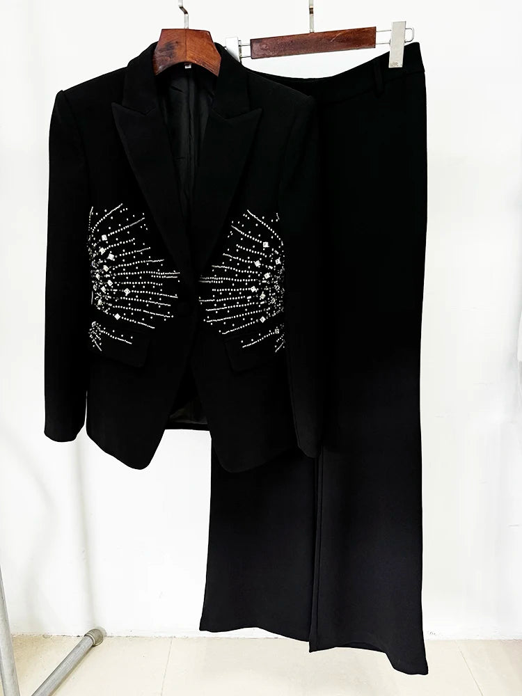 Black beaded blazer and straight leg pants hanging on a rack