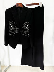 Black beaded blazer and straight leg pants hanging on a rack