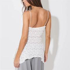 Woman wearing a white lace tank top against a plain background