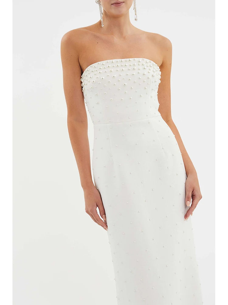 White strapless dress with bead detailing on a white background
