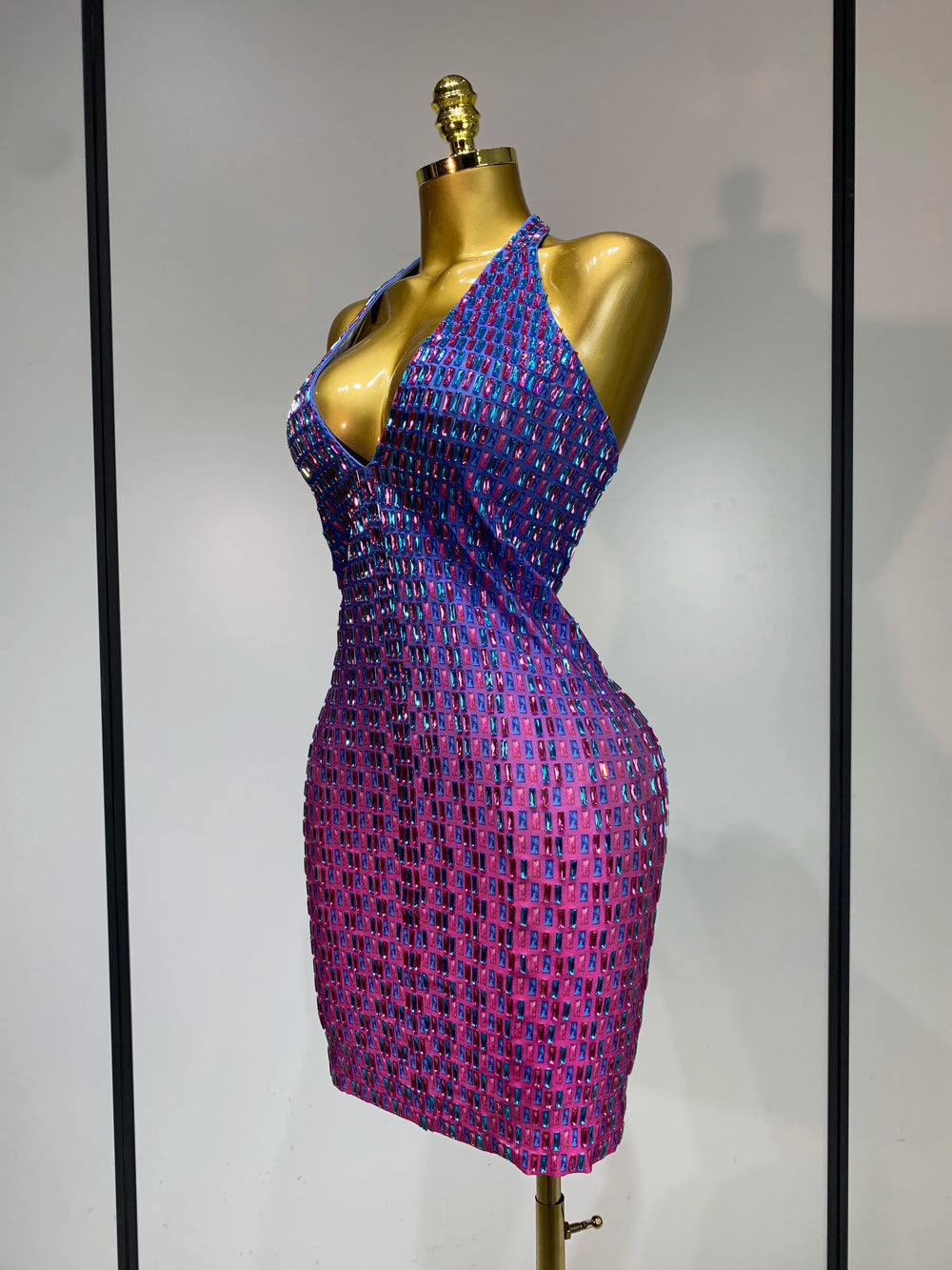Side view of halter neck bodycon mini dress with crystal embellishments