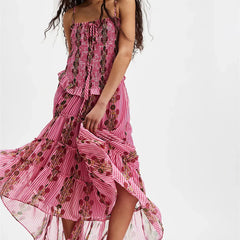 Pink floral dress with ruffled layers on a white background