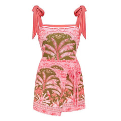 Close-up of the one-piece swimsuit and wrap skirt set with detailed botanical print.