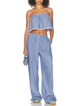 Woman wearing a blue striped outfit on a white background