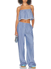 Woman wearing a blue striped outfit on a white background