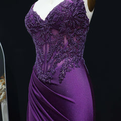 Purple evening gown with intricate beading on a mannequin against a black background