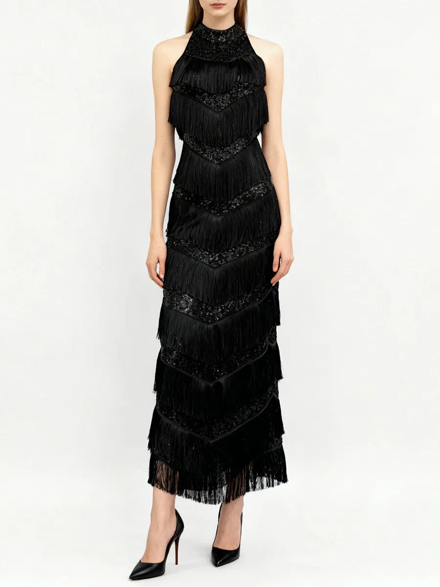 Black fringe dress worn by a model on a white background