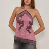 Pink halter top with floral designs and fringe details on a plain background