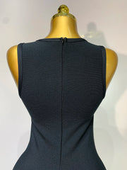 Black sleeveless dress on a mannequin with a plain background