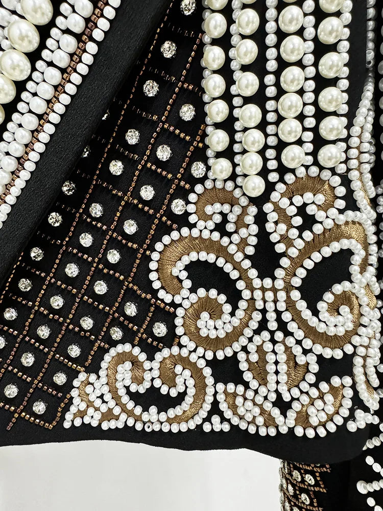 Detailed view of pearl and bead embroidery on cropped jacket