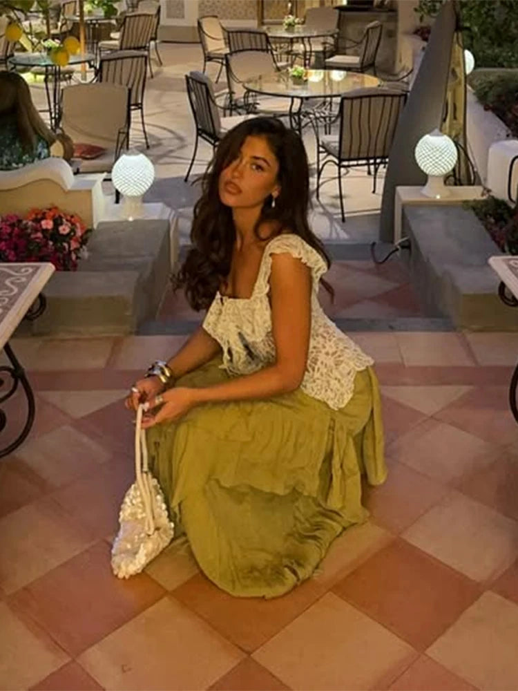 Woman sitting on a checkered floor in an outdoor cafe setting