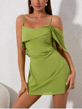 Green dress worn by a model against a neutral background