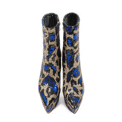 Pair of blue and gold sequin ankle boots on a white background