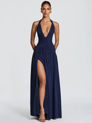 Navy blue evening gown with a deep neckline and high slit on a white background