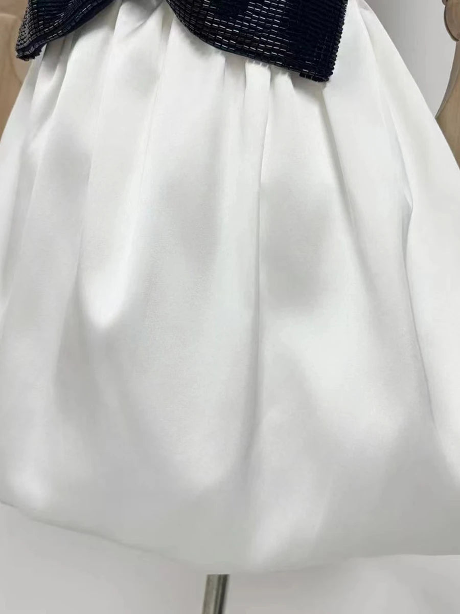 White skirt with a black waistband on a mannequin.